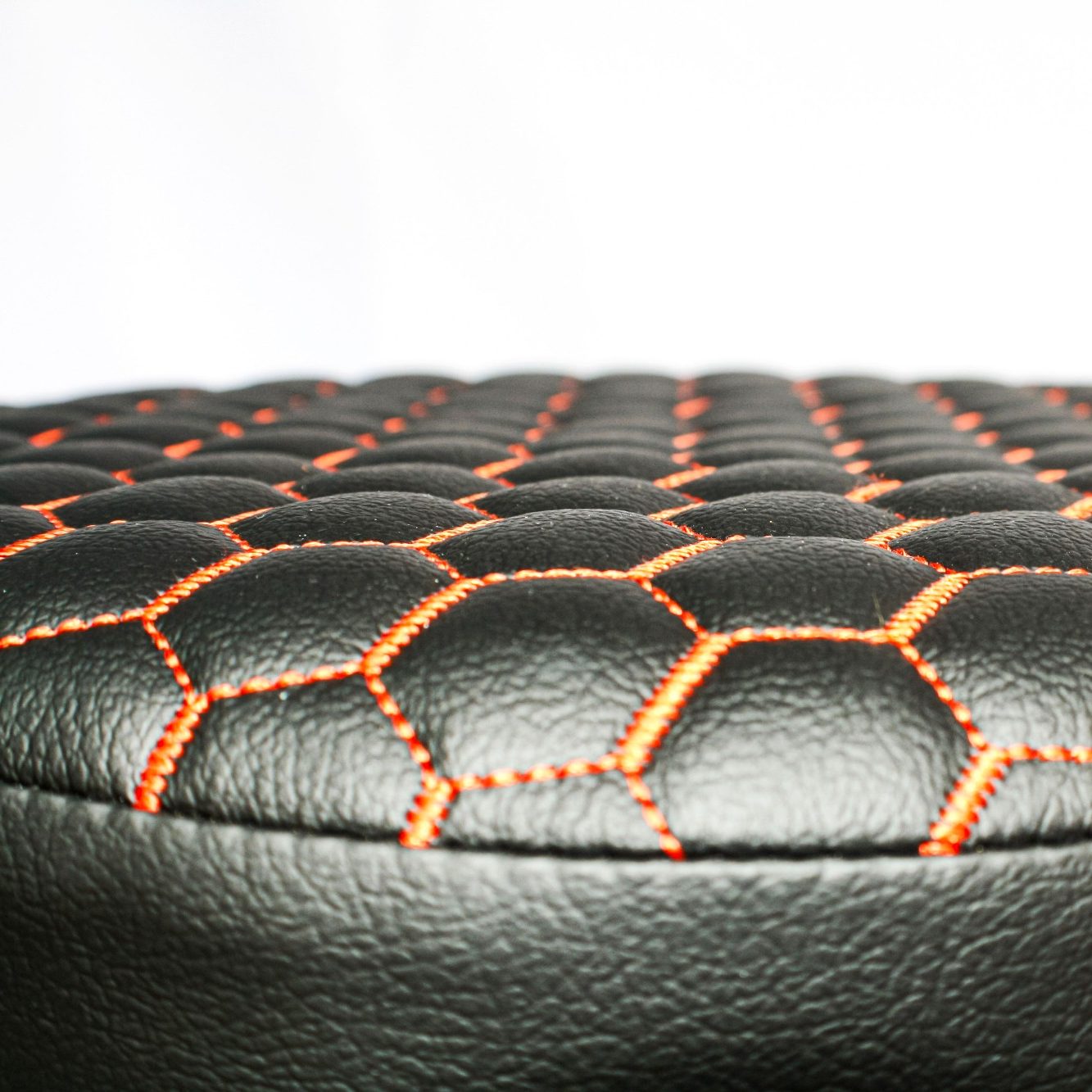 black material with orange honeycomb stitching